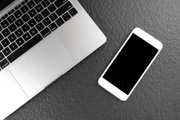 istock smartphone mock up with laptop on black tabletop 1205880052