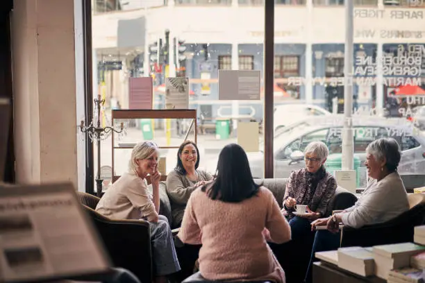 Shot of a group of women attending a book club meeting at a bookstore