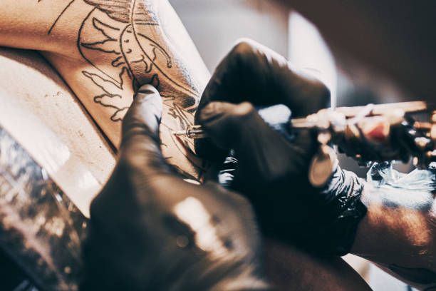 istock Tattoo Artist making a tattoo on a shoulder 1205881114