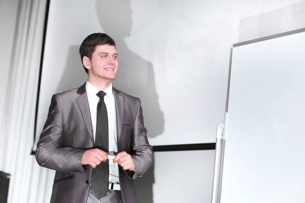istock speaker standing on the stage during a business presentation. 1205881904