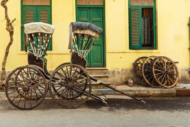 Hand pulled rickshaws are parkedon the street in Kolkata. India