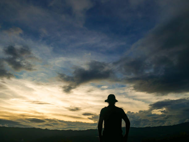 istock silhouette of a man standing in the mountains. 1205886394