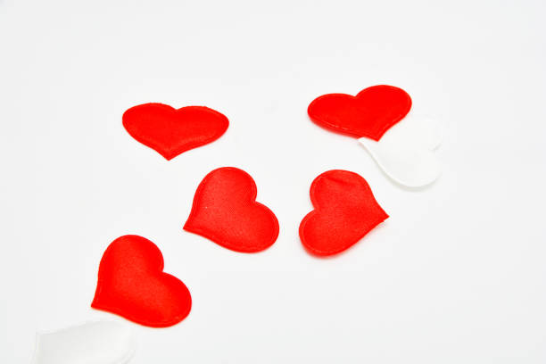 istock Red and white fabric hearts on a white background. Theme for Valentine's Day and holidays 1205887378