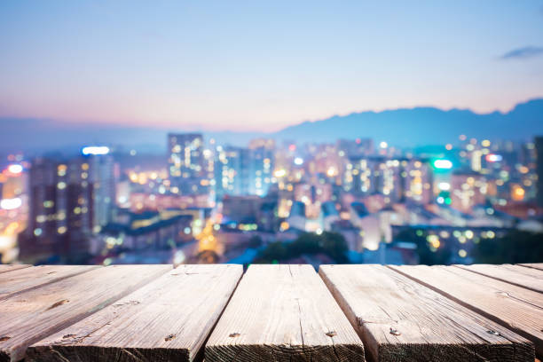 istock Blur city night with wood table 1205890382