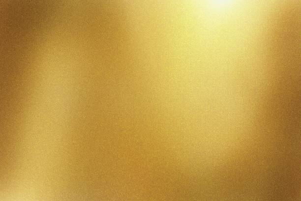 istock Light shining down on gold foil metal wall with copy space, abstract texture background 1205891786