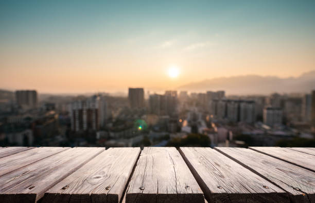 istock Empty wooden platform with urban skyline background 1205893290