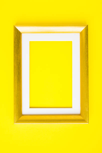 istock Empty picture frame gold wood frame on yellow 1205895039