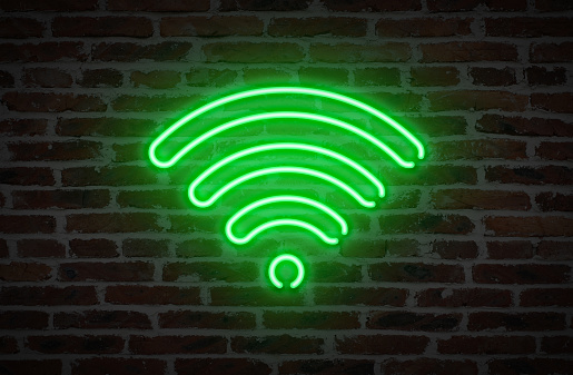 WIFI Symbol Neon Light Sign on Brick Wall Background.