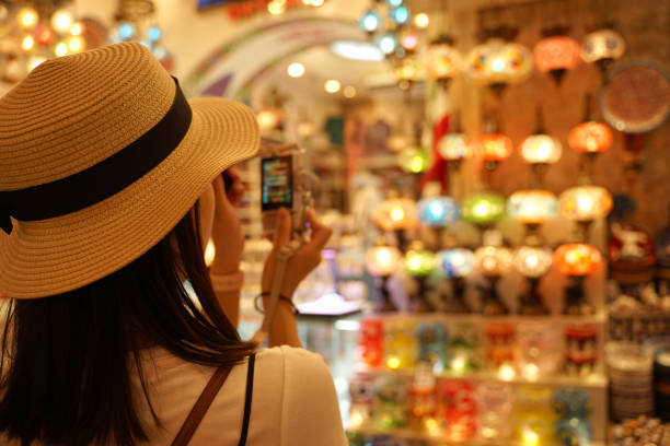 istock Asian woman wearing white hat taking photo with digital camera 1205898862