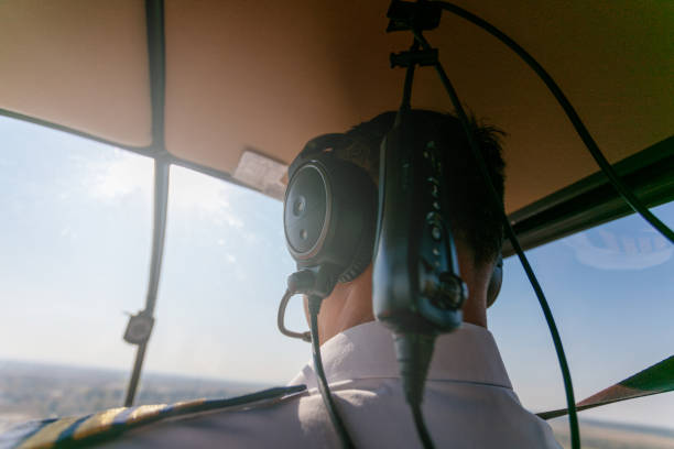 istock Pilot flying a helicopter with audio equipment on 1205901248