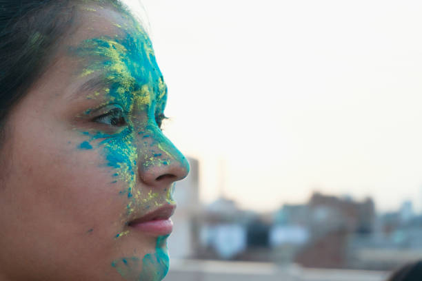 Portrait of a beautiful girl full of colored powder all over the body. outdoor shoot.