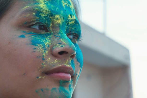 Portrait of a beautiful girl full of colored powder all over the body. outdoor shoot.