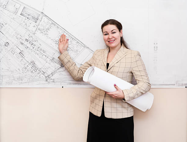 istock One young woman a architect standing near blueprint 120590216