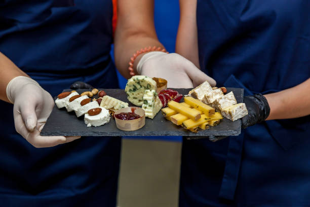 istock A cheese plate with cutting cheese on dark board 1205902334