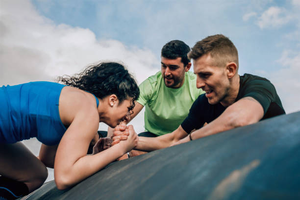 istock Woman in an obstacle course climbing a drum 1205905118