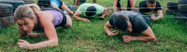 Photo of Participants in an obstacle course crawling