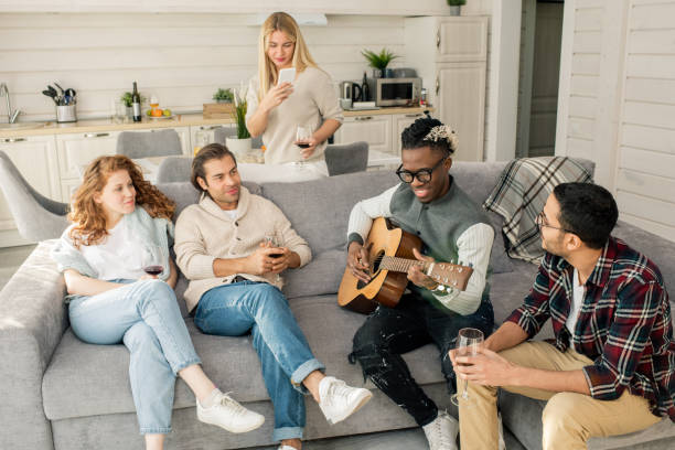 istock Friends Listening To Man Playing Guitar 1205905177