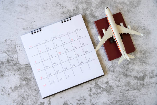 istock Airplane model with paper calendar. plan for trip 1205905926