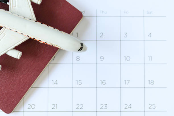 istock Airplane model with paper calendar. plan for trip 1205905928
