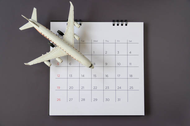 istock Airplane model with paper calendar. plan for trip 1205905941
