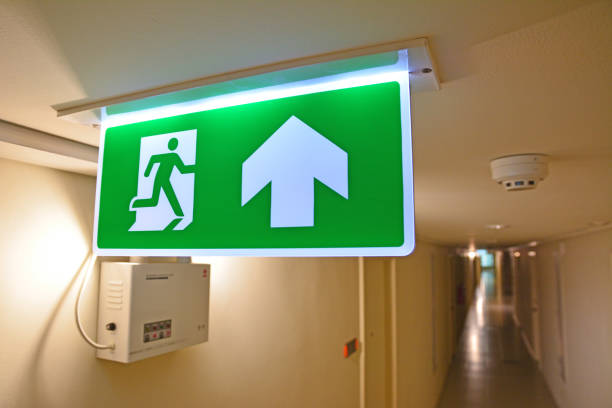 istock Emergency light and Emergency Fire exit sign at  the corridor in building 1205906104
