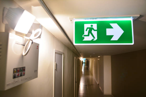 istock Emergency light and Emergency Fire exit sign at  the corridor in building 1205906117