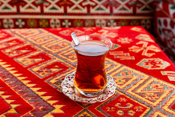 istock Hot Turkish Tea Cup on a Table with traditional Turkish Tablecloth 1205908730