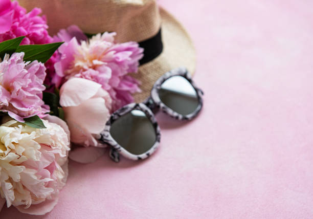istock Pink peonies and hat on a pink concrete background 1205910029