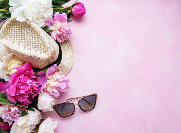 istock Pink peonies and hat on a pink concrete background 1205910030