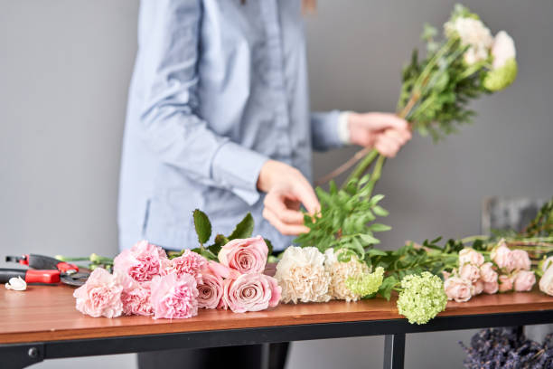 istock Education in the school of floristry. Master class on making bouquets. Summer bouquet. Learning flower arranging, making beautiful bouquets with your own hands. Flowers delivery 1205910043