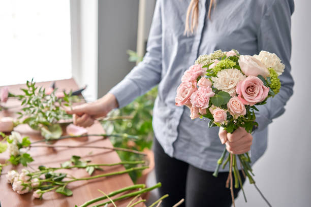 istock Education in the school of floristry. Master class on making bouquets. Summer bouquet. Learning flower arranging, making beautiful bouquets with your own hands. Flowers delivery 1205910696
