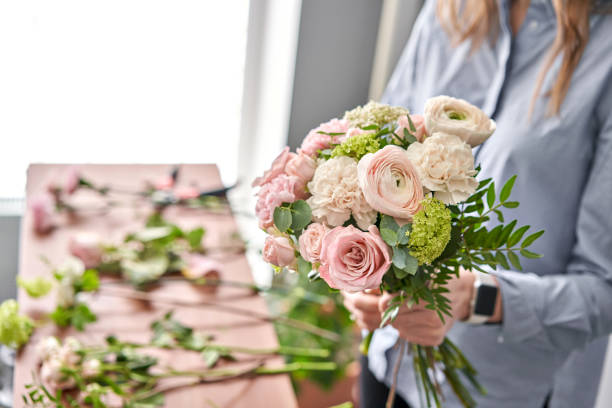 istock Education in the school of floristry. Master class on making bouquets. Summer bouquet. Learning flower arranging, making beautiful bouquets with your own hands. Flowers delivery 1205910708