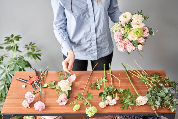 istock Education in the school of floristry. Master class on making bouquets. Summer bouquet. Learning flower arranging, making beautiful bouquets with your own hands. Flowers delivery 1205910725