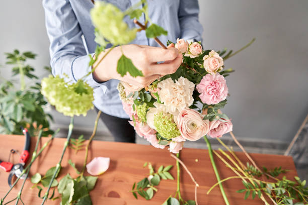 istock Education in the school of floristry. Master class on making bouquets. Summer bouquet. Learning flower arranging, making beautiful bouquets with your own hands. Flowers delivery 1205910731