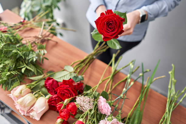 istock Education in the school of floristry. Master class on making bouquets. Summer bouquet. Learning flower arranging, making beautiful bouquets with your own hands. Flowers delivery 1205911037