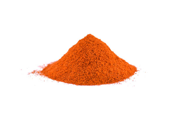 istock Red chili pepper powder isolated on white background 1205911514