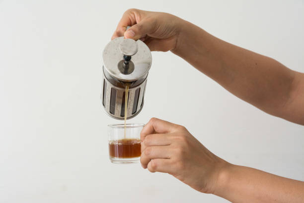 istock Hand holding a French Press coffee on white background 1205913655