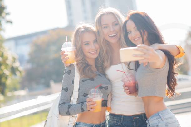 istock Girlfriends have fun in the city in the summer 1205913741