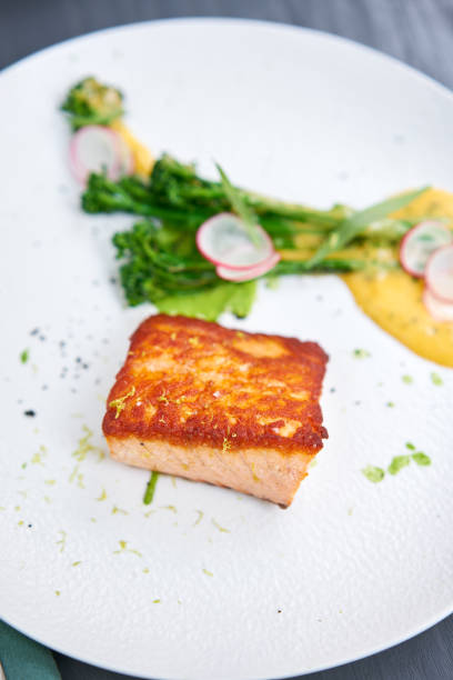Salmon steak fillet and garnished with young broccoli. Restaurant menu, a series of photos of different dishes
