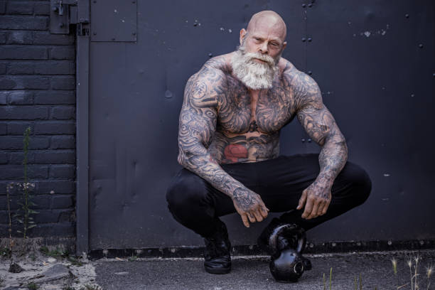 Bearded Aggressive Senior Man during workout in an outdoor gym