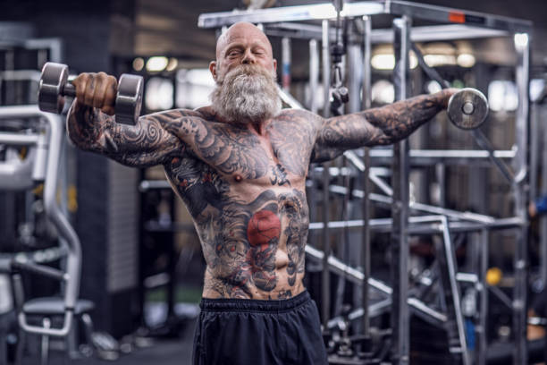 istock Tattooed Senior Man During Gym Workout 1205916382