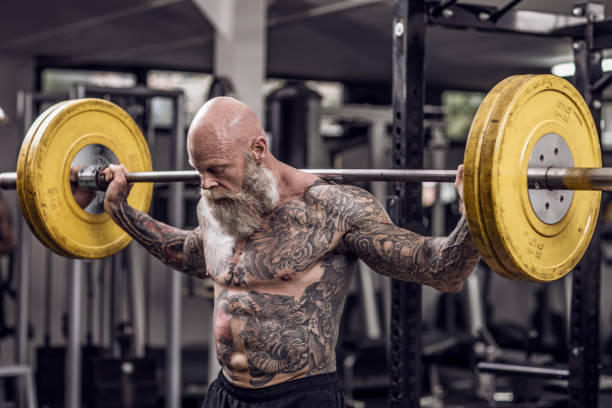 istock Tattooed Senior Man During Gym Workout 1205916943