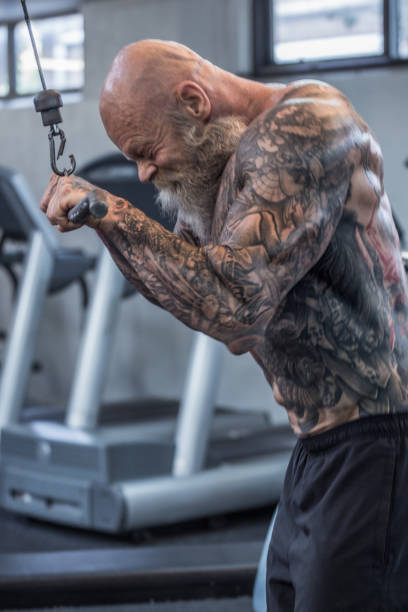 istock Tattooed Senior Man During Gym Workout 1205917077