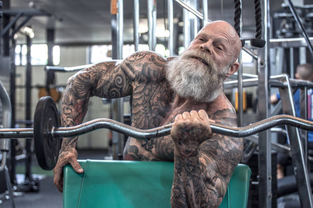 istock Tattooed Senior Man During Gym Workout 1205917650