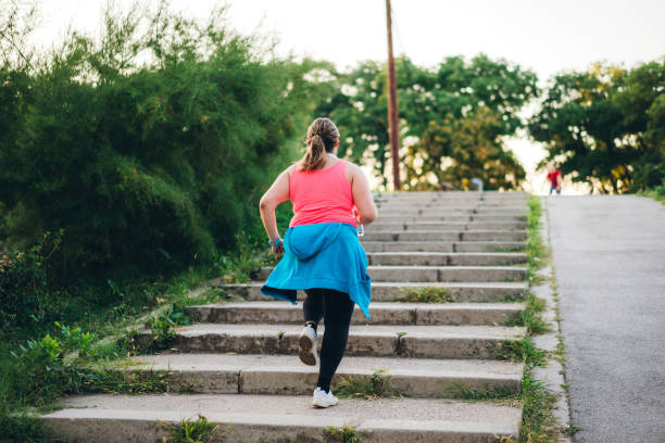 istock Young overweight woman running 1205917855