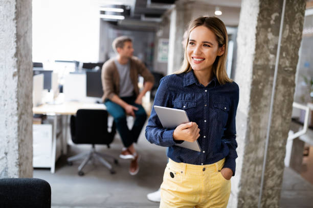 istock Portrait of a smiling designer, student, freelancer business woman using tablet computer 1205921085
