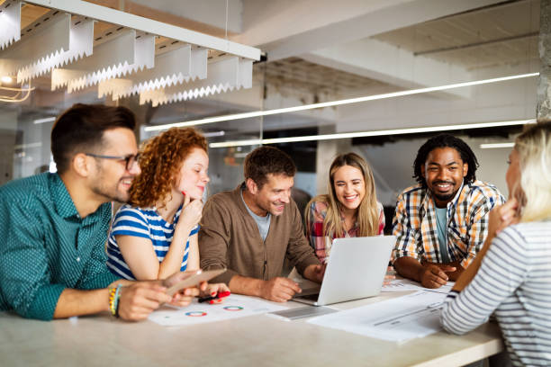 istock Creative brainstorming. Happy business people, designers, architects working as a team in office 1205921176