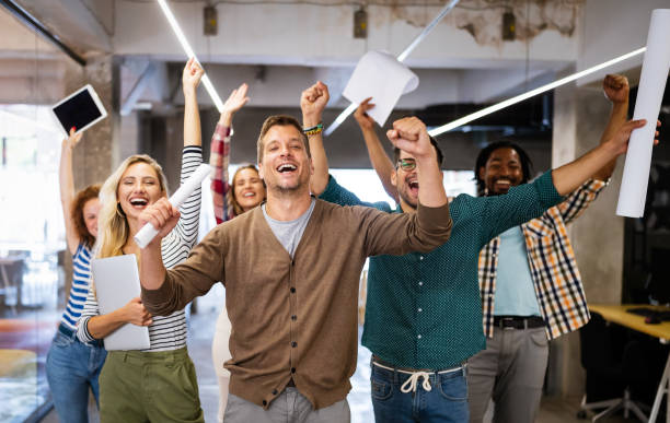 istock Happy business people celebrating success at company 1205921237