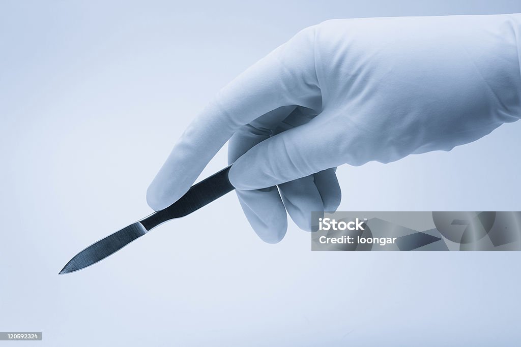 surgeon hand with scalpel during surgery Surgery Stock Photo