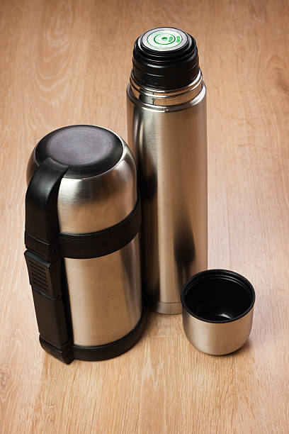 istock two thermoses on the wooden table 120592454